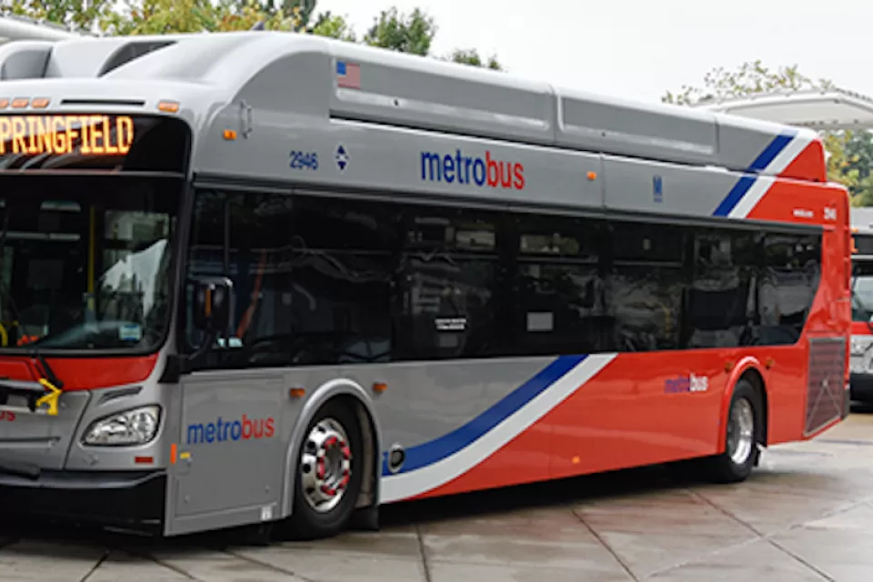 Silver and red WMATA public bus at station in Washington, D.C.